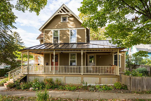 Exterior Front Face to N, showing  porch extension on R and Addition